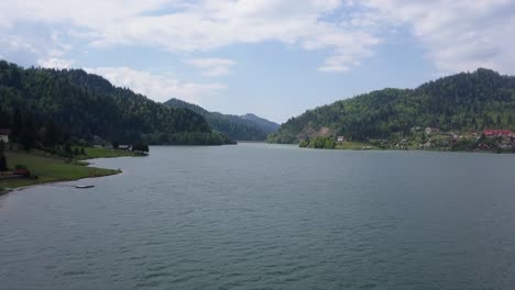 Aerial-Slow-moving-shot-of-Valley-with-Lake-and-trees