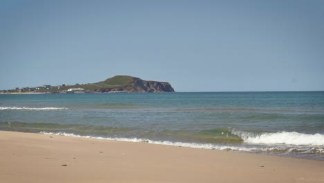 Beautiful-coastline-on-a-sandy-beach-in-the-Magdalen-Islands,-on-a-bright-sunny-day-in-slow-motion