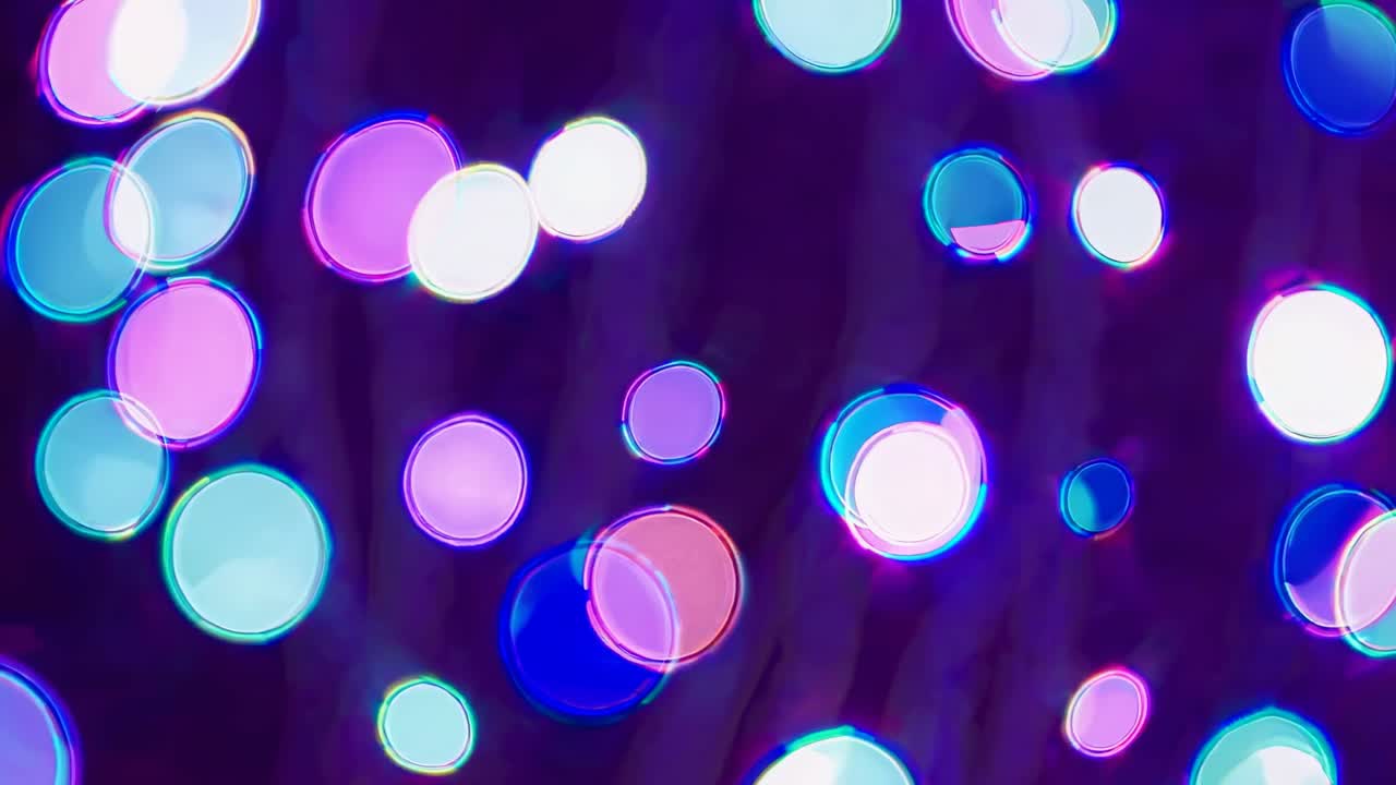 Abstract video with a bokeh effect, featuring colorful circles in pink and blue hues