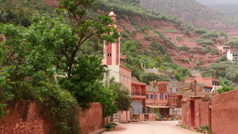 person drying moroccan carpets in a building of rural traditional village in atlas mountain range