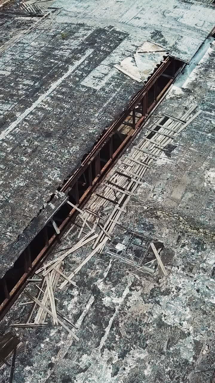 Ruins of an old factory. Old industrial building for demolition. Aerial view. Vertical video