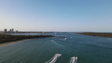 watersports activities in a protected ocean harbor close to a coastal city skyline