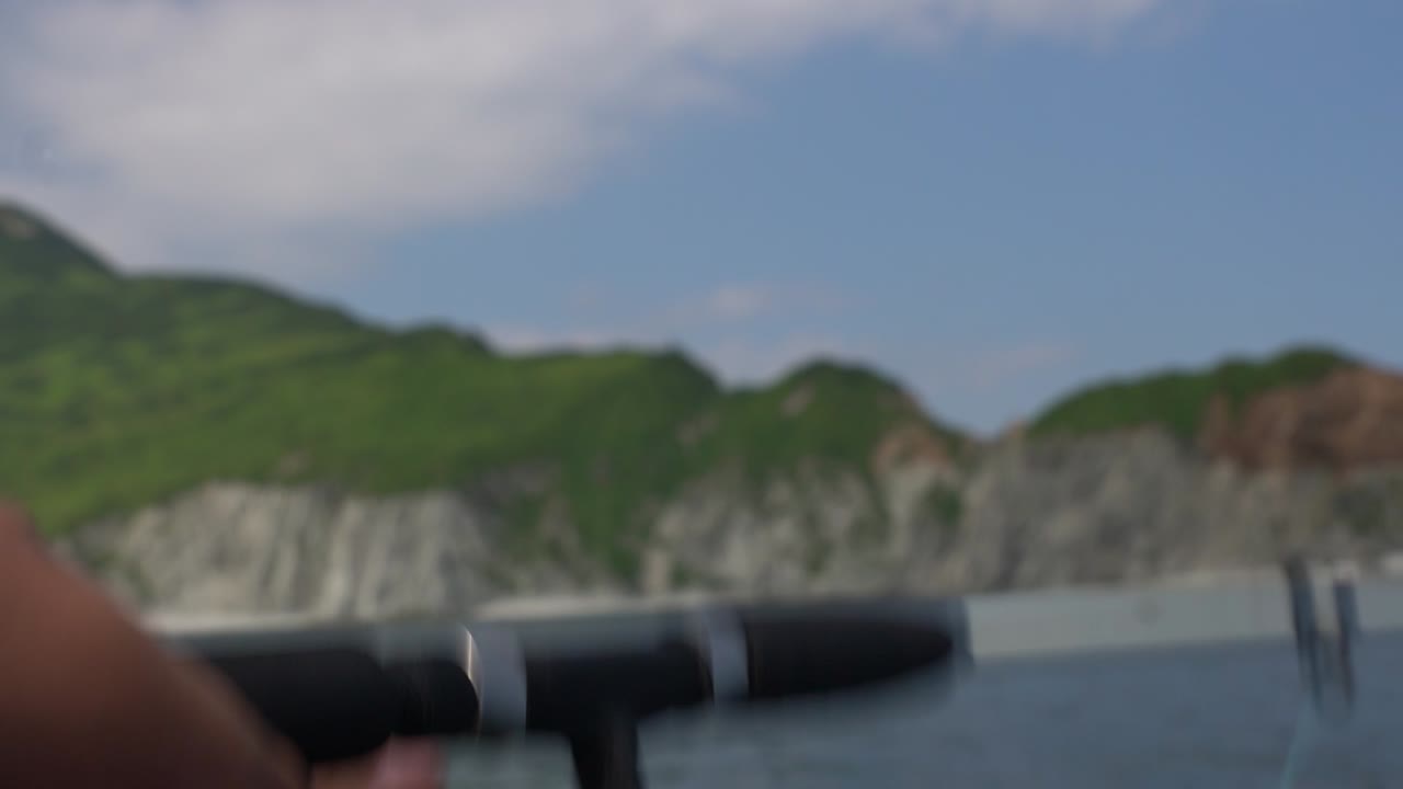 Fishing from a boat on a beautiful coastal scene