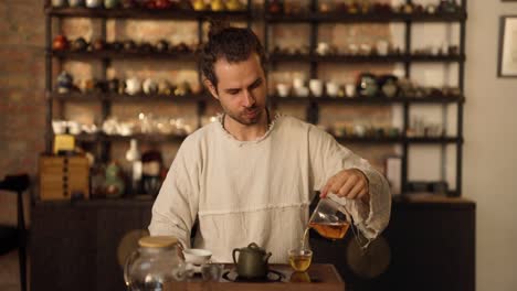 man making tea in a traditional tea ceremony