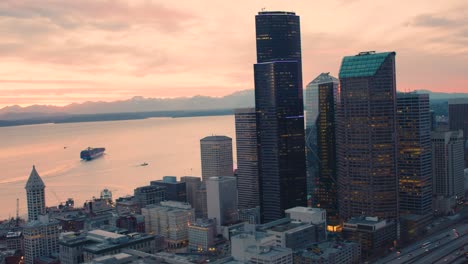 colorful orange skies illuminate glorious seattle bay waterfront downtown towers cargo ships amazing landscape