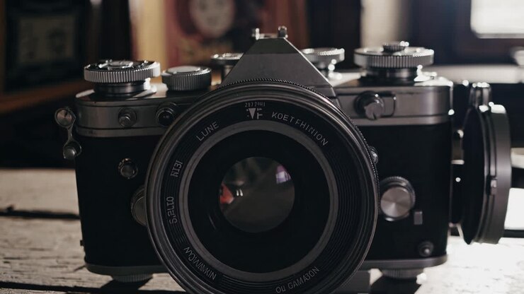 Vintage camera on rustic wooden table, shot from a low angle