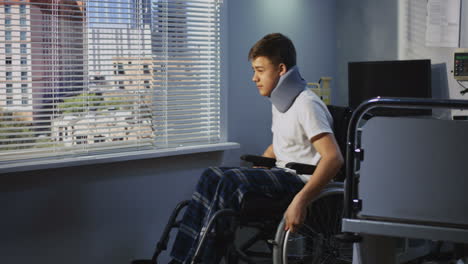 injured teenager in hospital wheelchair