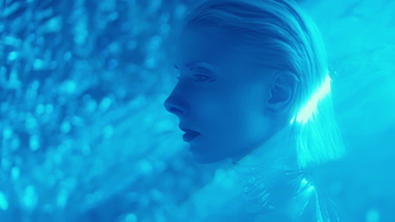 Extraterrestrial Woman Walking through Projection of Laser Light