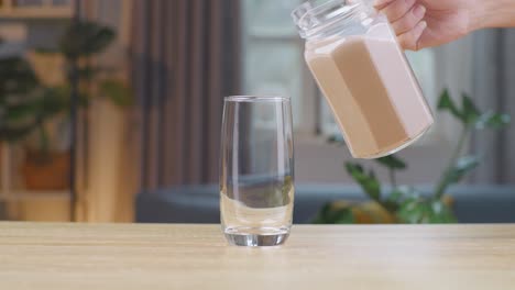 slow motion pour chocolate milk drink in tumbler glass