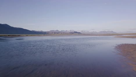 Low-Flight-Over-the-Sandy-River-Bank-During-Sunny-Summer-In-Snaefellsness-Peninsula,-Iceland