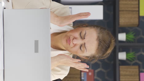 Vertical-video-of-Business-woman-sad-seeing-his-failure-on-laptop.