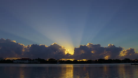 Sunburst-Into-Blue-Sky-Over-Inlet-In-South-Florida,-U