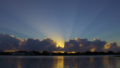 sunburst into blue sky over inlet in south florida, u