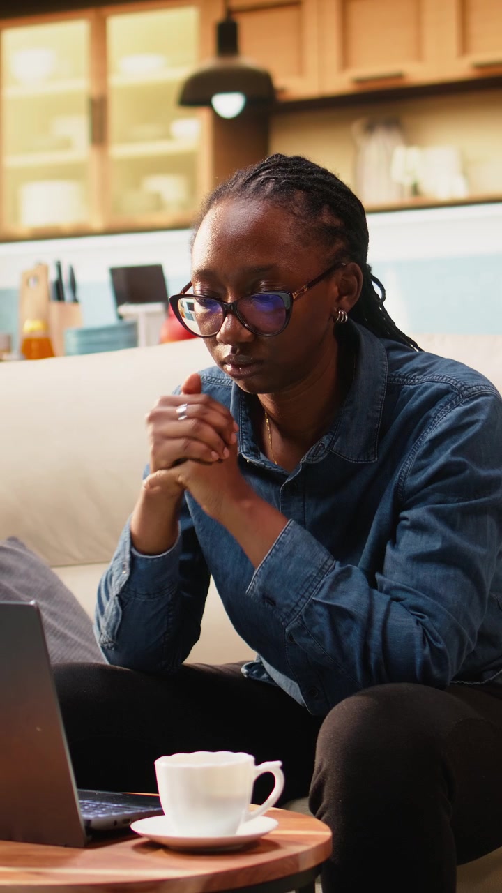 Vertical Video Young woman cracking knuckles due to nervous habit at home