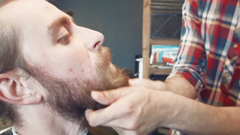 man getting a beard trim at the barber shop