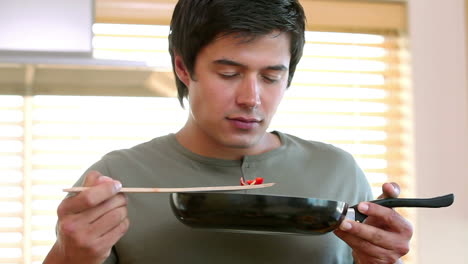 man smelling his cooking