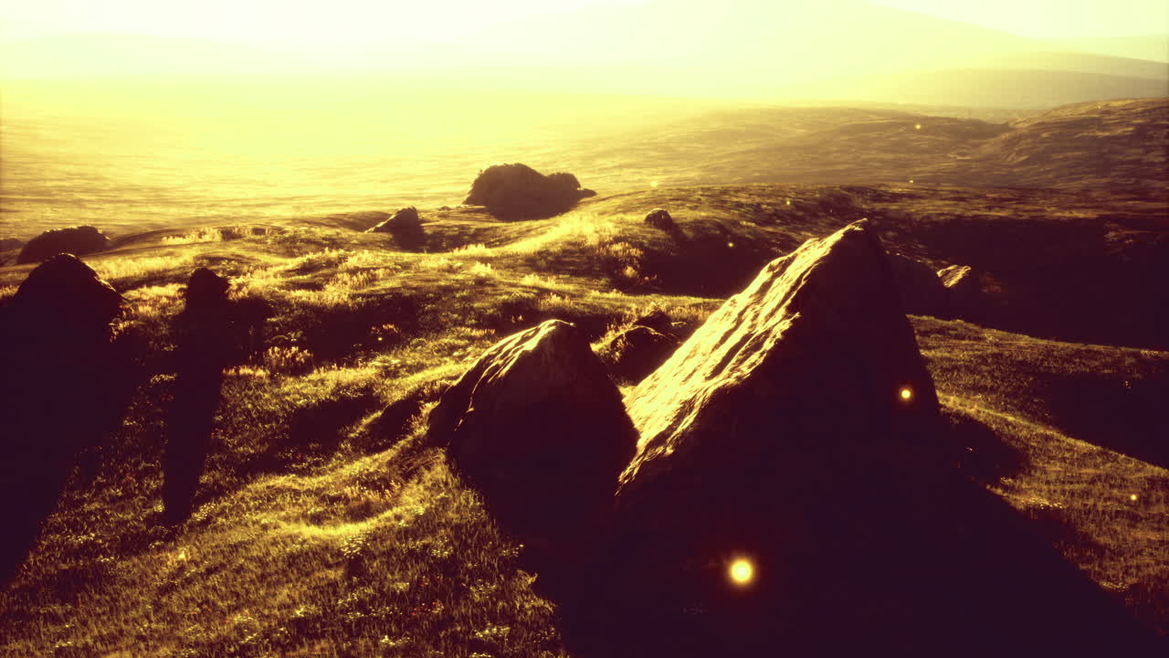 Golden sunlight illuminates rocky terrain in a serene landscape view