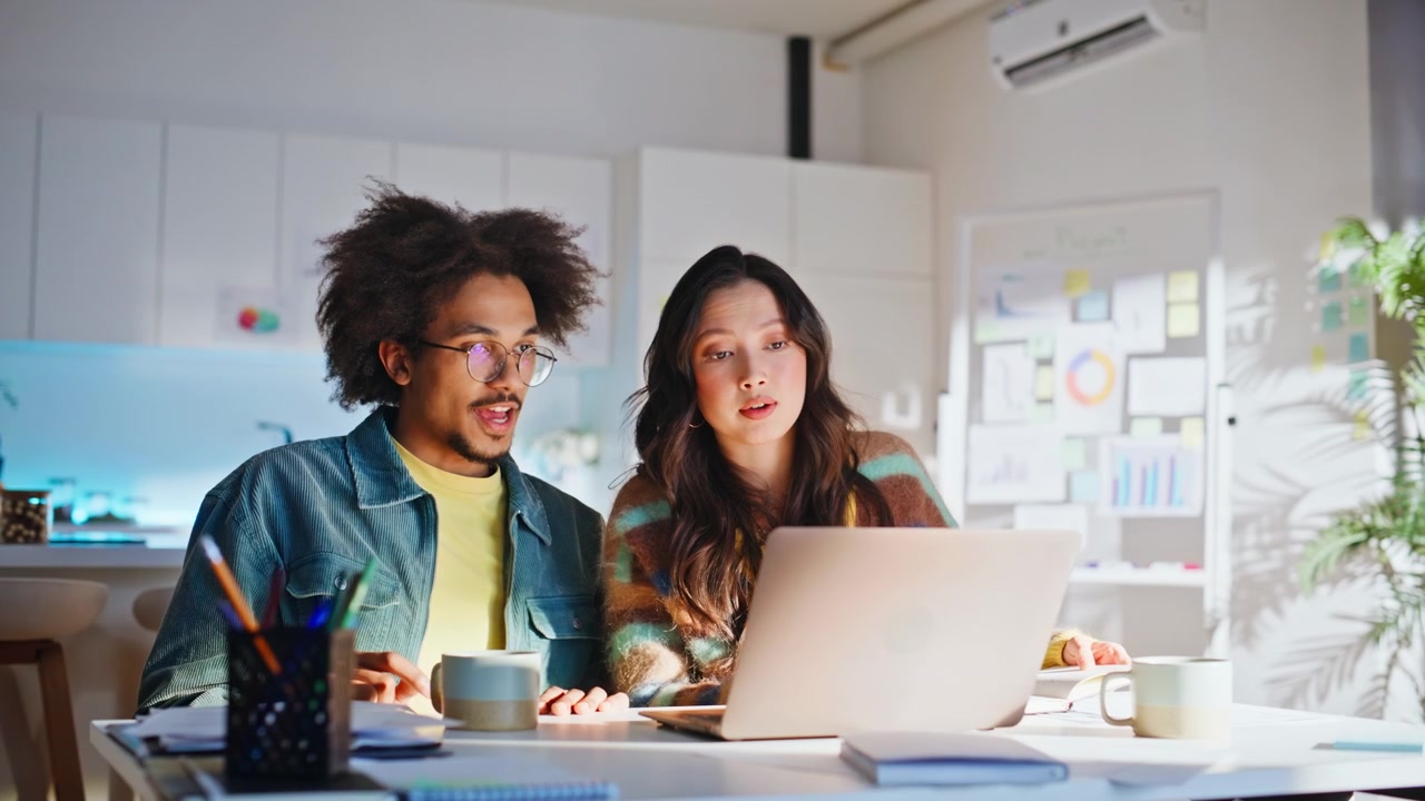Diverse colleagues gesturing ideas laptop. Man woman teamwork creative office.