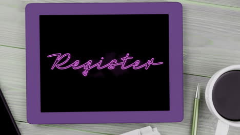 animation of pink neon style word register flickering on screen of digital tablet put on desk