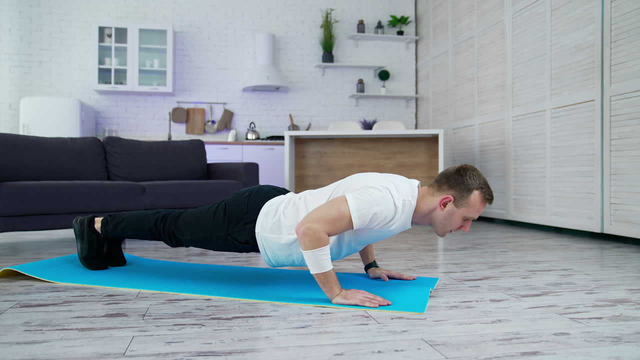Home working out by healthy strong man. Man indoor doing exercise in quarantine.