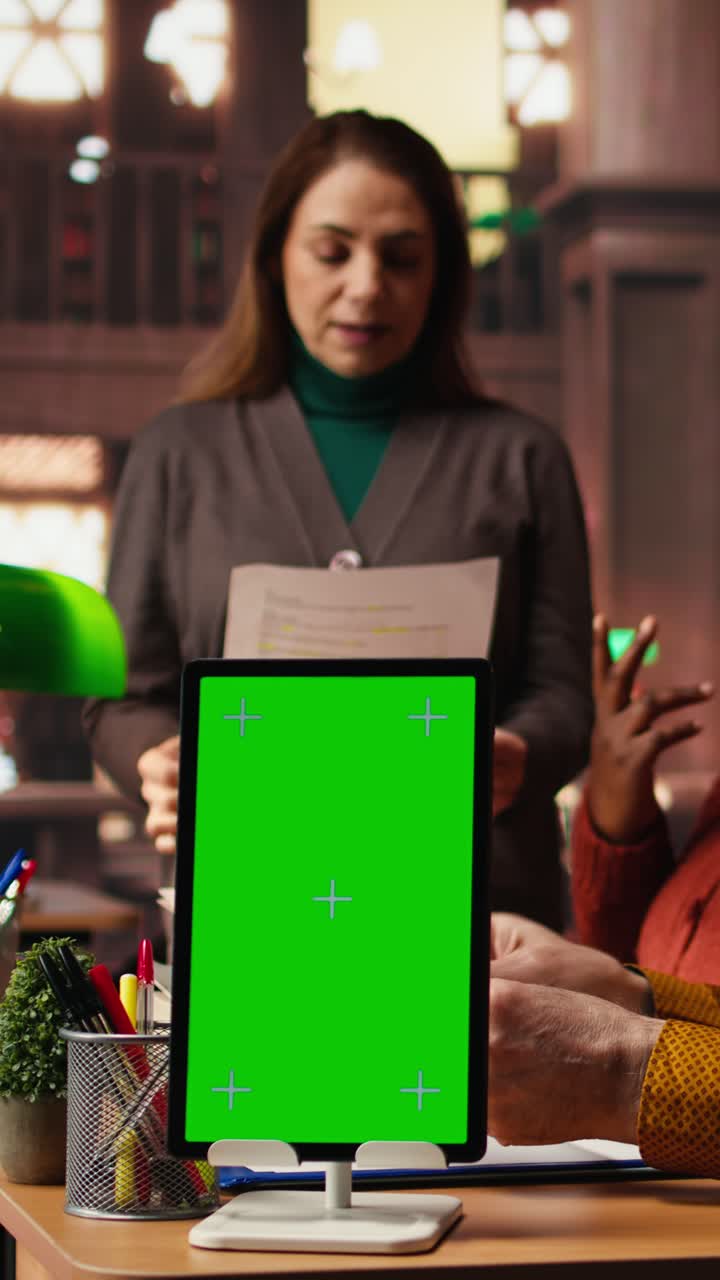 Vertical Video Focused diverse people studying in public library with green screen on pc