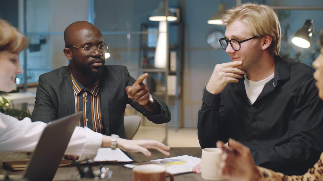 Multiethnic Business Team Having Office Meeting at Night
