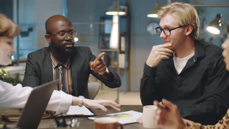 Multiethnic-Business-Team-Having-Office-Meeting-at-Night