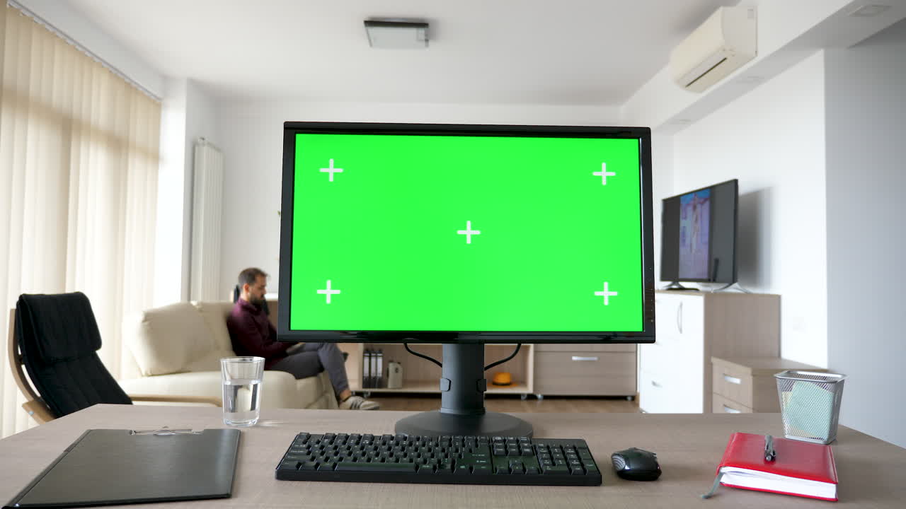 Office setup with a green screen monitor