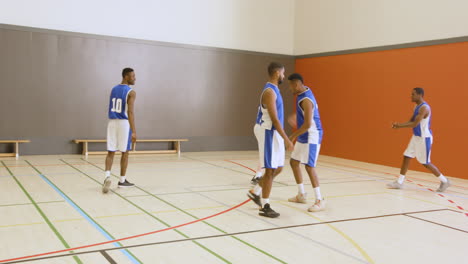 practicing teamwork and strategy, basketball players in school gymnasium