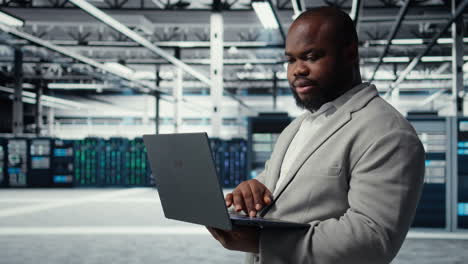 vertical video engineer in data center using laptop to update storage arrays