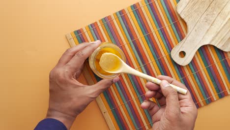 person holding a spoon with ghee