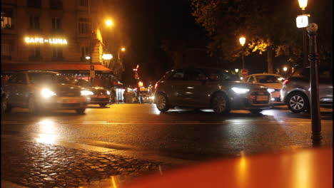 city street at night with cafe and cars