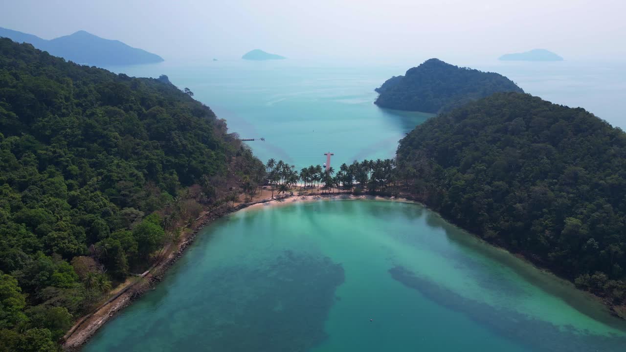 Scenic aerial view of lush green hills and turquoise waters on Koh Chang Ngam Island. Best aerial view flight ascending drone