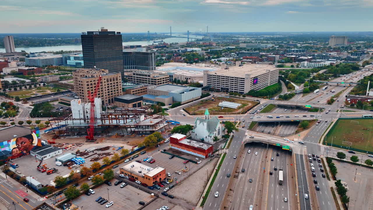 Transport moves by the multi-lane highway with multiple bridges above. Traffic in Detroit, Michigan, USA. Aerial view
