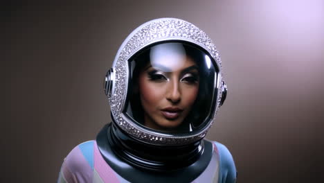 woman in a sparkling, jeweled astronaut helmet