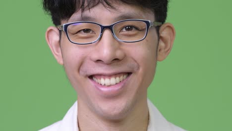 head shot of young asian businessman smiling