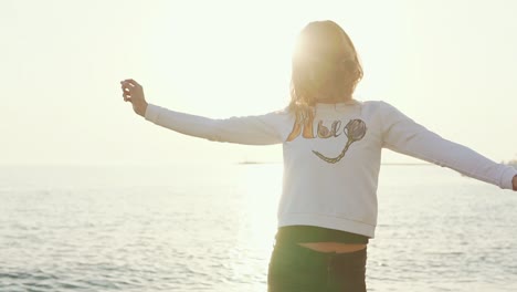 woman enjoying a sunset on the beach