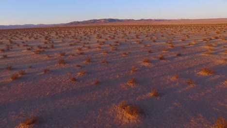 A-beautiful-fast-moving-low-aerial-over-the-Mojave-desert-at-sunrise-or-sunset-1