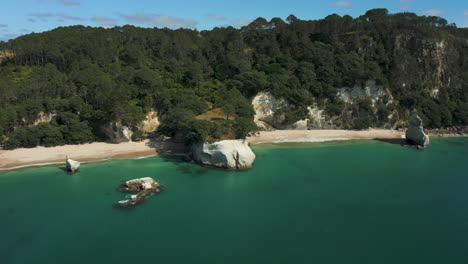 cathedral cove beach filming location for the music video "can't hold us" by macklemore - drone orbit