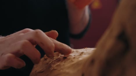 close up of hands shaping soft clay with precision during sculpting process