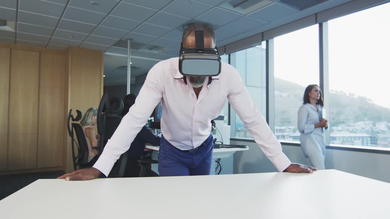 African American businessman wearing VR headset in modern office