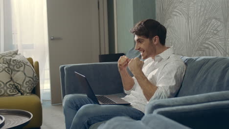 successful man showing yes gesture indoors. happy guy getting letter computer