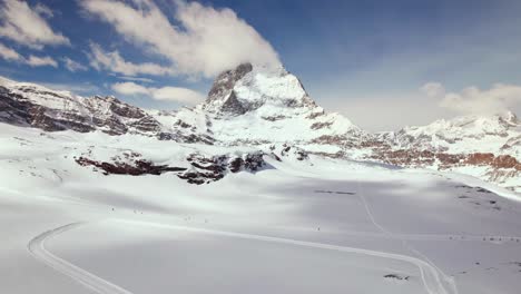 aerial of skier on a slope in zermatt ski resort near matterhorn mountain