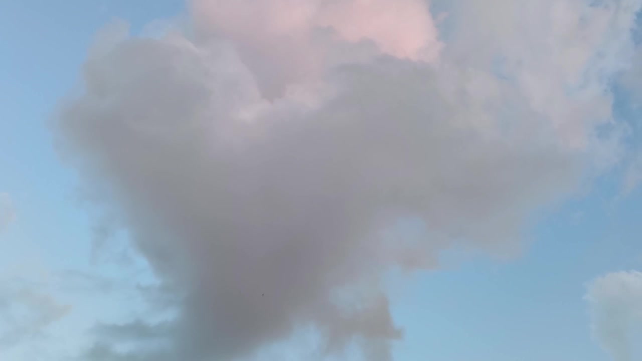 Large Cloud Moving Across Blue Sky at Sunset