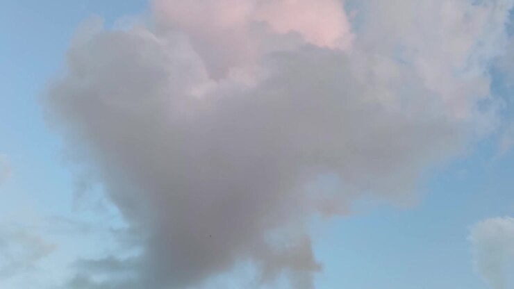 Large Cloud Moving Across Blue Sky at Sunset