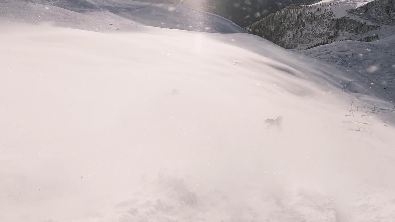 Cinematic downhill freeride skiing of two professional ski mountain guides in fresh deep snow with amazing mountain landscape
