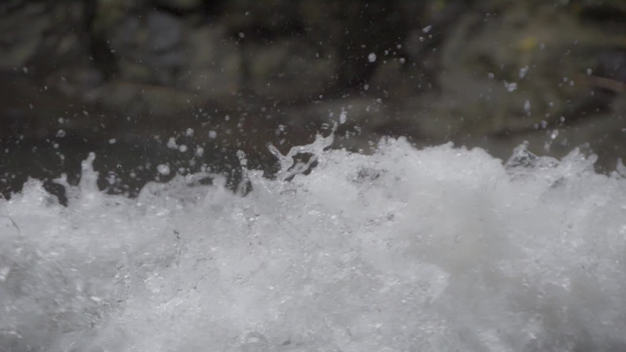 Close-up of powerful, rushing white water in a fast-moving river