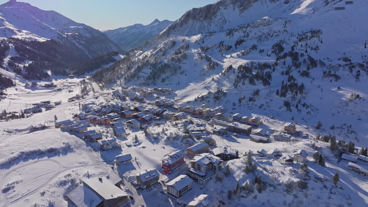 Drone view of snow-blanketed alpine village in Obertauern, Austria