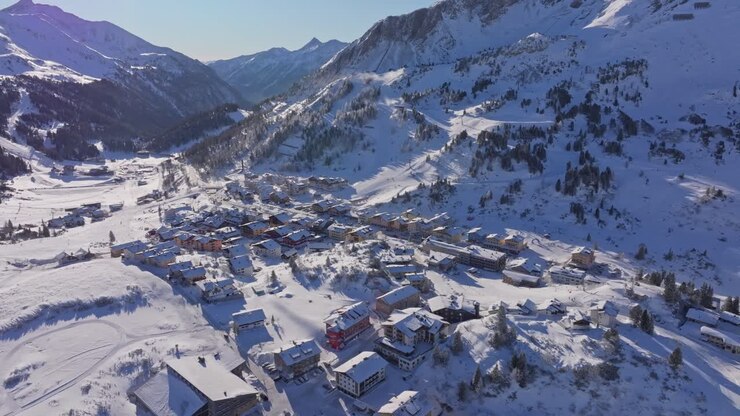 Drone view of snow-blanketed alpine village in Obertauern, Austria