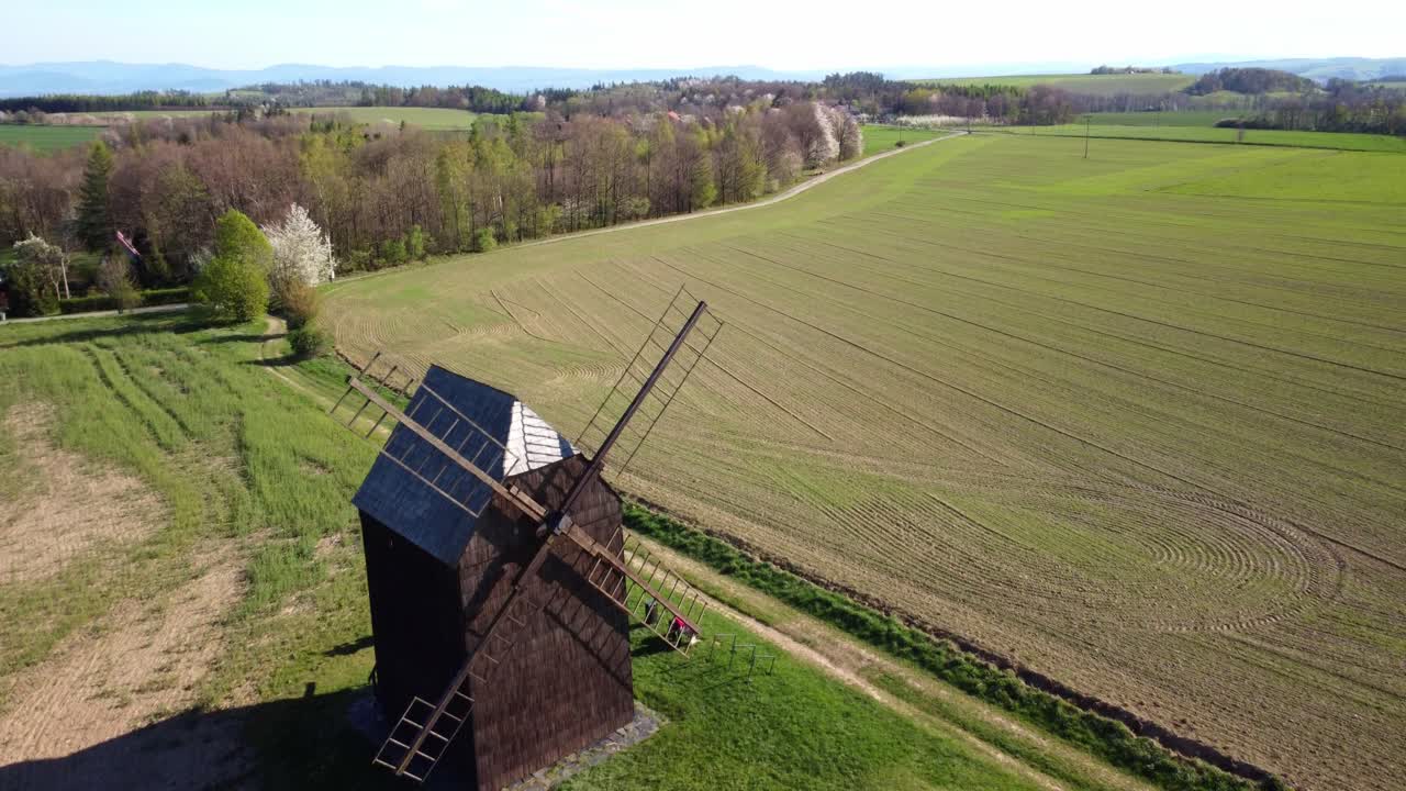 Historic Wooden Windmill in a Rural Landscape